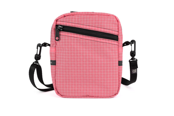 An Everyday Cubelet in Cubelet Halcyon (pale pink with a white grid) with a front zipper.